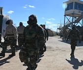Members of the Gladiator Resolve training event proceed to the next instruction outfitted in Mission Oriented Protective Posture (MOPP) gear at Joint Base San Antonio-Lackland, Texas on Feb. 5, 2024. The equipment mitigates potential exposure to chemical, biological, radiological, and nuclear (CBRN) contaminants. (US Air Force photo by Alex Dieguez)