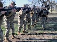 Members assess their ready stance during Small Arms training at Joint Base San Antonio-Lackland, Texas on Feb. 6, 2024. All members who deploy to forward locations must be familiar with small arms in support of effective Force Protection. (US Air Force photo by Alex Dieguez)
