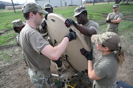 Members of the 960th Cyberspace Wing are instructed through the teardown of expeditionary communications (XCOMM) equipment at Joint Base San Antonio-Lackland, Texas on Feb. 8, 2024. The scale of the military satellite and associated components supports agile repositioning and rapid employment of C2 support. (US Air Force photo by Alex Dieguez)