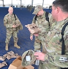 CMSgt Richard Monforti recounts some of his experiences with fellow Airmen while selecting Meals, Ready-to-Eat (MREs) at JBSA-Lackland, Texas on Feb. 8, 2024. Exercises and training events make frequent use of MREs as a cost-effective, compact option for field supplies. (US Air Force photo by Alex Dieguez)