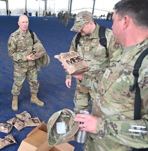 CMSgt Richard Monforti recounts some of his experiences with fellow Airmen while selecting Meals, Ready-to-Eat (MREs) at JBSA-Lackland, Texas on Feb. 8, 2024. Exercises and training events make frequent use of MREs as a cost-effective, compact option for field supplies. (US Air Force photo by Alex Dieguez)