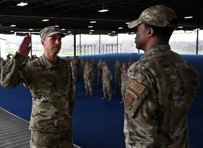 Col. Silas Darden presides over SMSgt Joshua Mayeux’s re-enlistment and recites the oath of enlistment for him to repeat following the conclusion of the training event at JBSA-Lackland, Texas on Feb. 9, 2024. (US Air Force photo by Alex Dieguez)