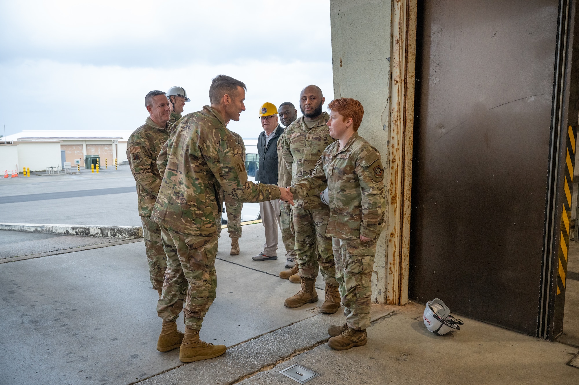 Service members shake hands.
