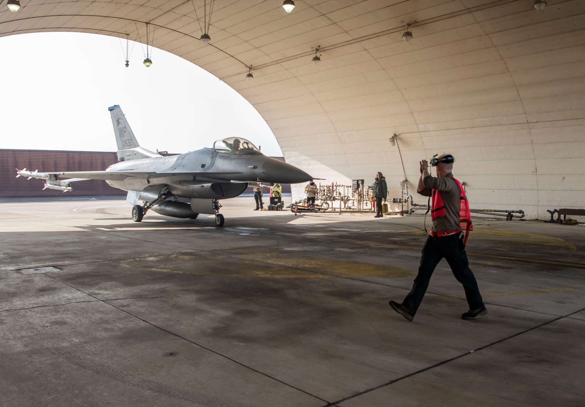 U.S. Air Force Airman 1st Class Kristopher Pearce, 36th Fighter Generation Squadron crew chief, marshals an F-16 Fighting Falcon at Osan Air Base