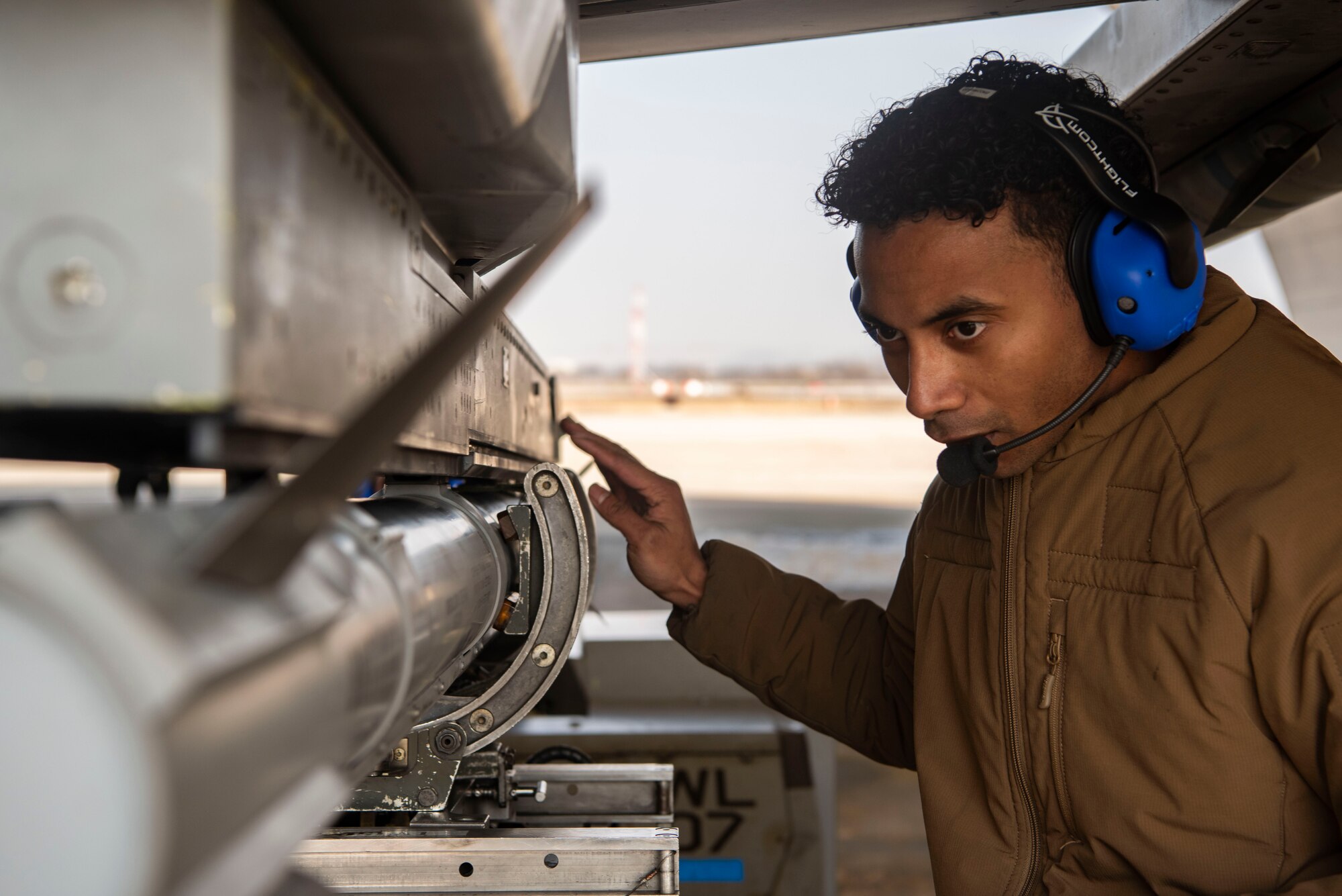 U.S. Air Force Staff Sgt. Malik Van Diver, 36th Fighter Generation Squadron weapons load crew chief, begins to remove an AIM-9X Sidewinder from an F-16 Fighting Falcon at Osan Air Base