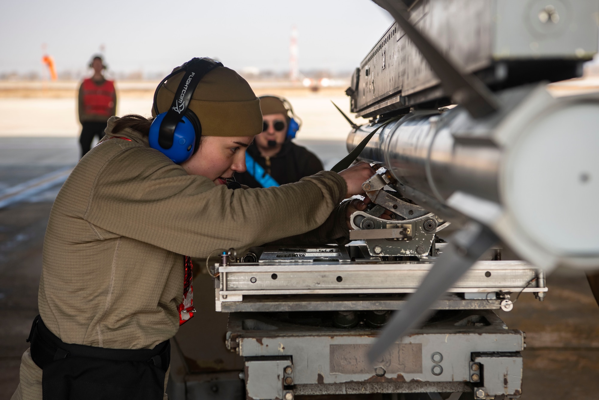 U.S. Air Force Airman 1st Class Katelyn Paba, 36th Fighter Generation Squadron weapons load crew member, secures an AIM-9X Sidewinder from an F-16 Fighting Falcon at Osan Air Base