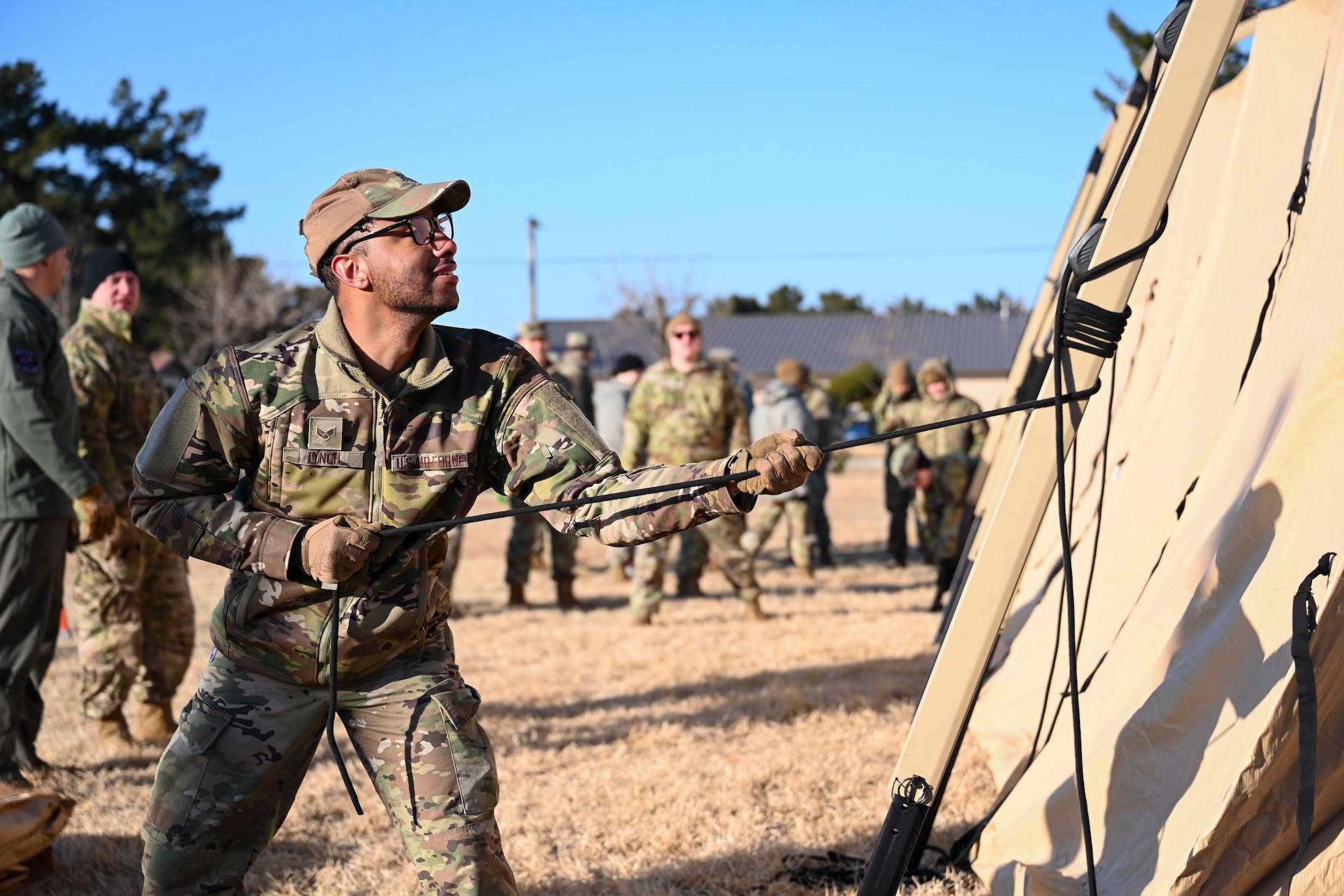 Senior Airman Jaylin Lynch, 8th Healthcare Operations Squadron medical logistics technician, practices tightening the cord of an expeditionary medical support health response team tent at Kunsan Air Base, Republic of Korea.