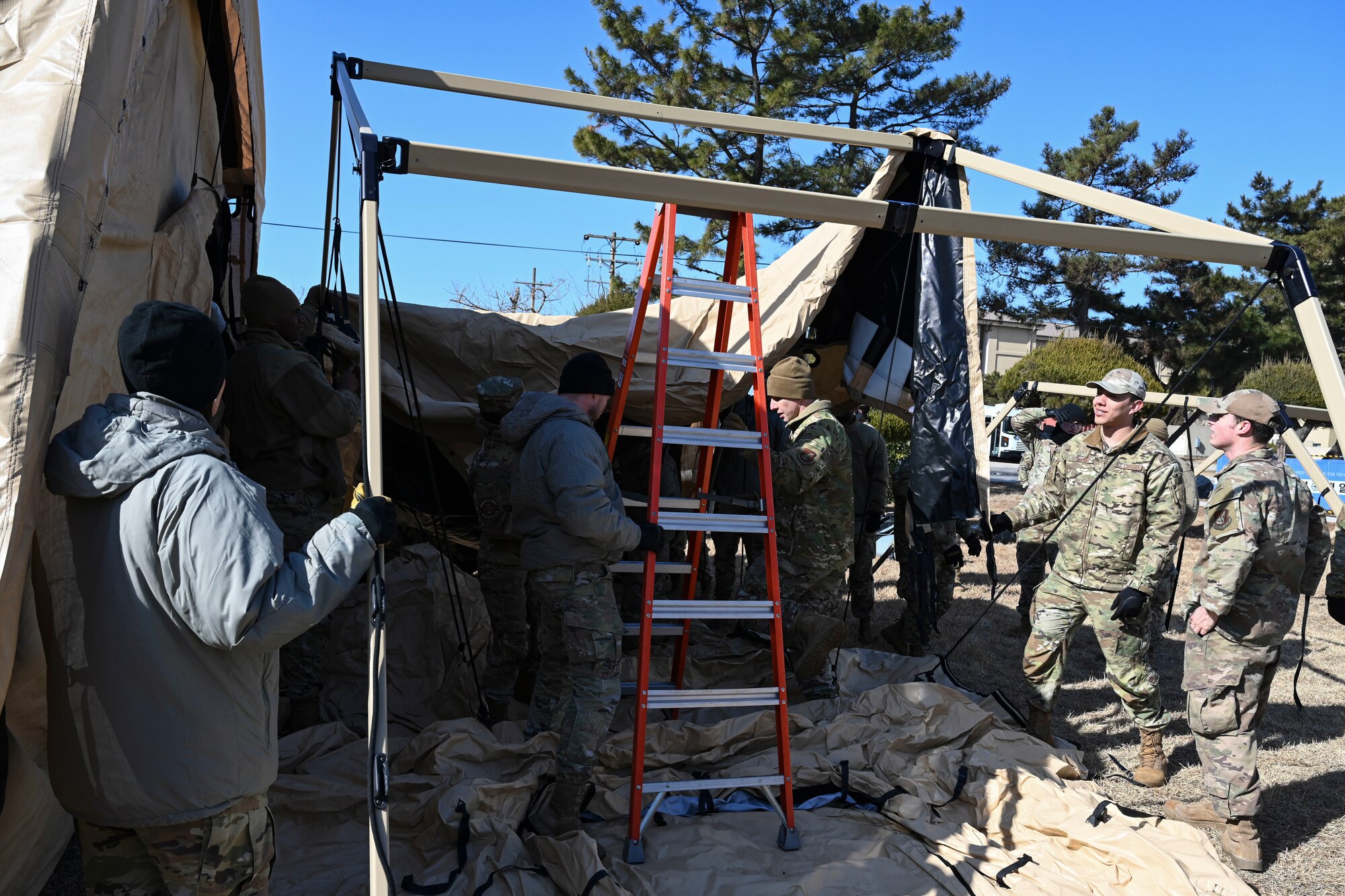 Airmen from the 8th Medical Group prepare to drape the covering of a medical tent during an expeditionary medical support health response team training at Kunsan Air Base, Republic of Korea.