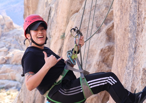 Hospitalman 1st Class Raquel Patino, from Van Nuys, Calif., with Navy Medicine Readiness and Training Command (NMRTC) Twentynine Palms, rappels down a rock face during a resilience-building event at Joshua Tree National Park, Feb. 5, 2025. The event, organized to enhance spiritual fitness and mental fortitude, challenged participants with rock climbing, caving, and rappelling in the park’s rugged terrain (U.S. Navy photo by Christopher C. Jones, NHTP/NMRTC Twentynine Palms public affairs officer).