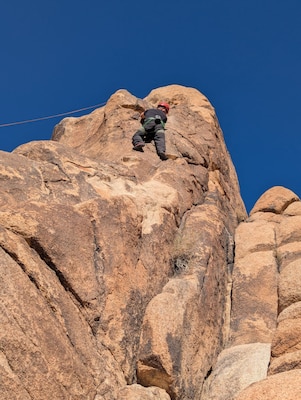 Sailors from Navy Medicine Readiness and Training Command (NMRTC) Twentynine Palms and Marines from Marine Corps Base Camp Pendleton participate in rock climbing during a resilience-building event at Joshua Tree National Park, Feb. 5, 2025. The event pushed participants to overcome physical and mental challenges through rock climbing, rappelling, and caving, fostering teamwork and perseverance in the park’s rugged landscape (U.S. Navy photo by Christopher C. Jones, NHTP/NMRTC Twentynine Palms public affairs officer).
