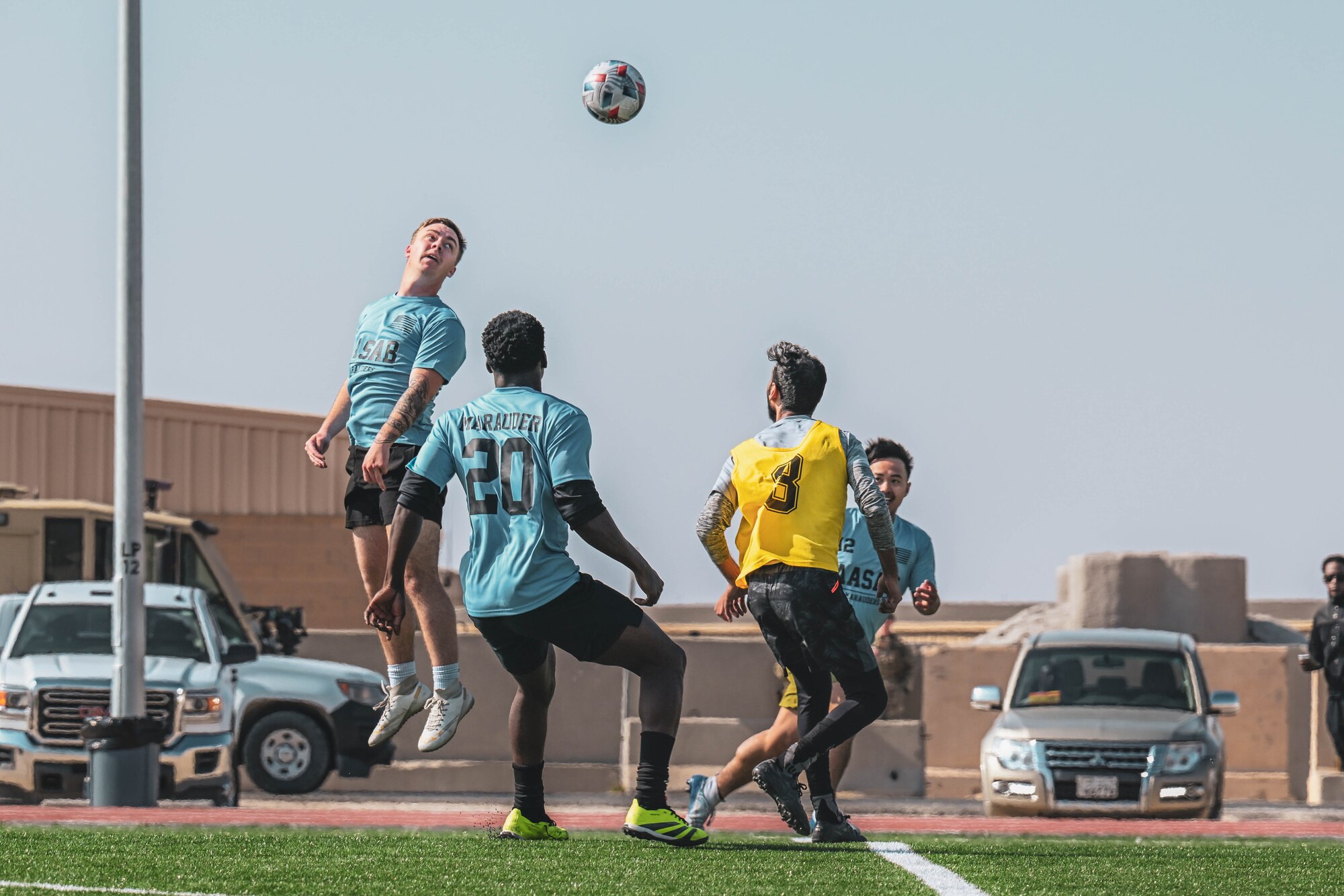Men play soccer together on a field.