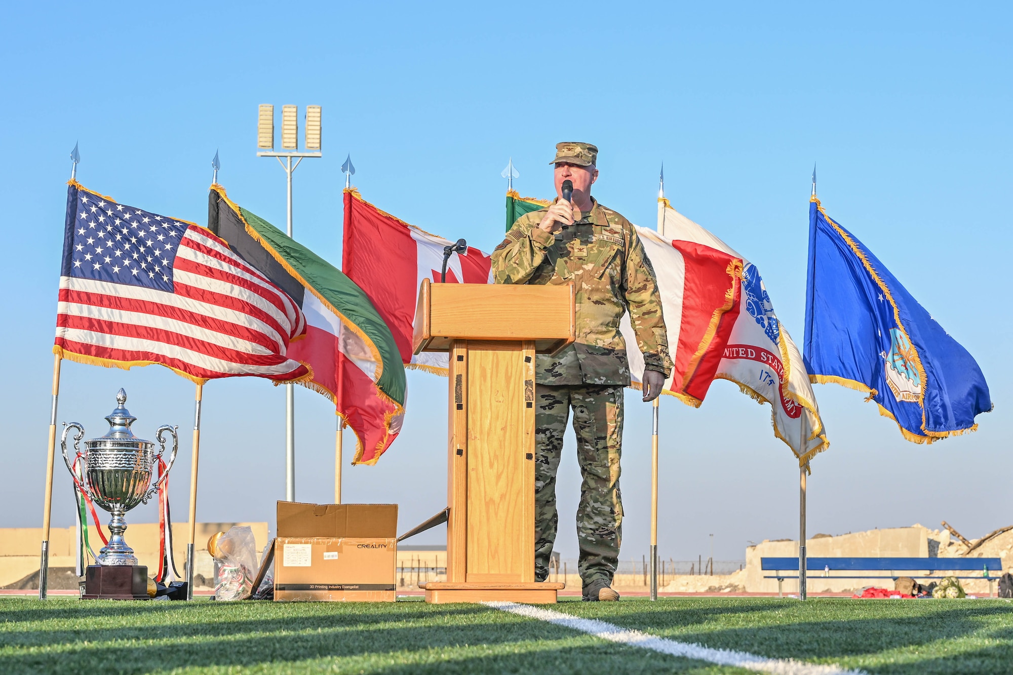 A man in uniform speaks into a microphone.