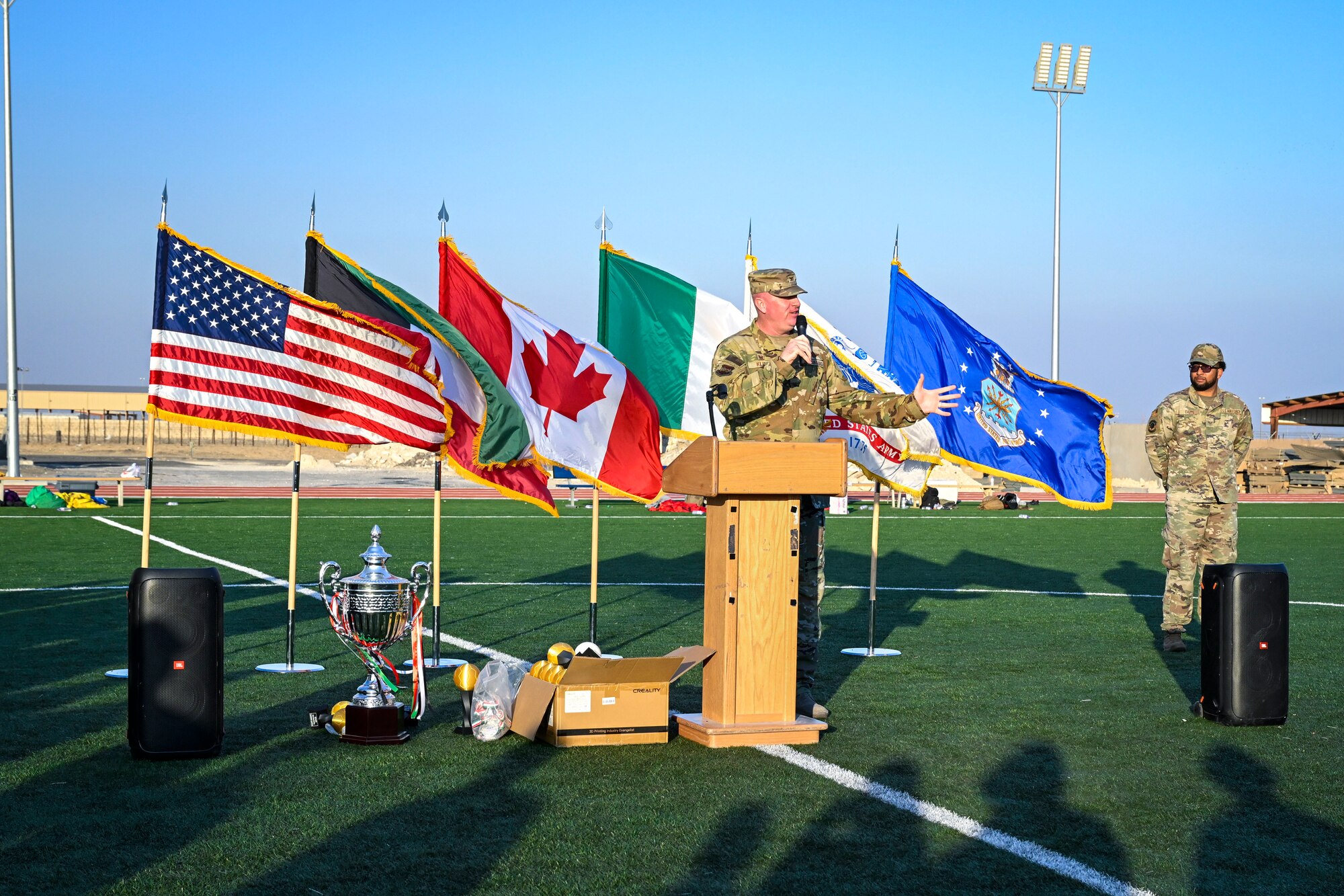 A man in uniform speaks into a microphone.