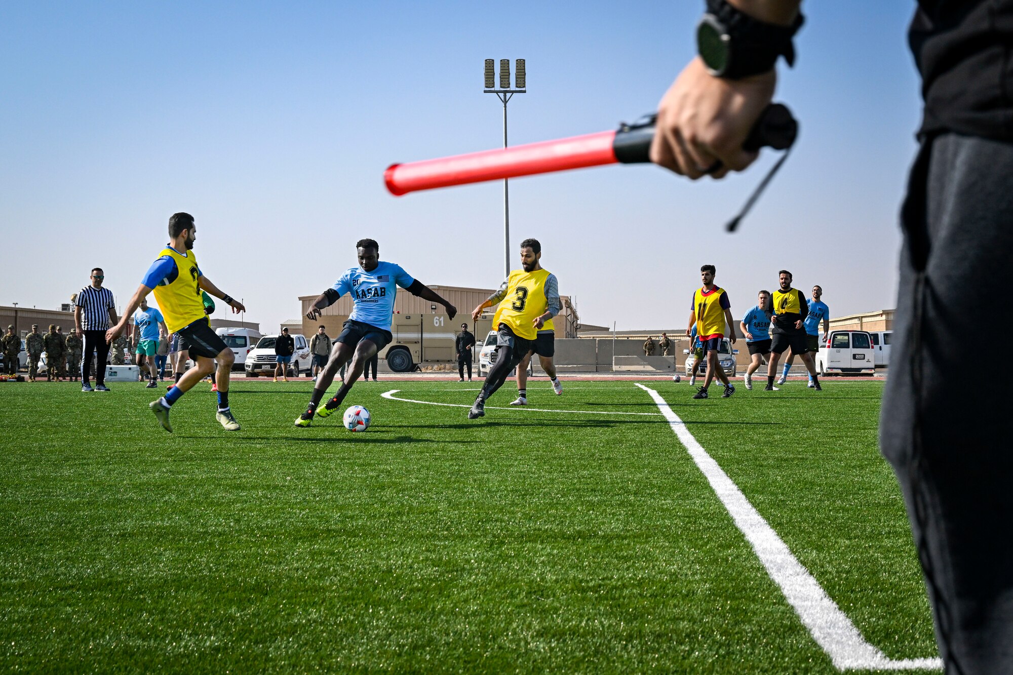 A group of men play soccer.