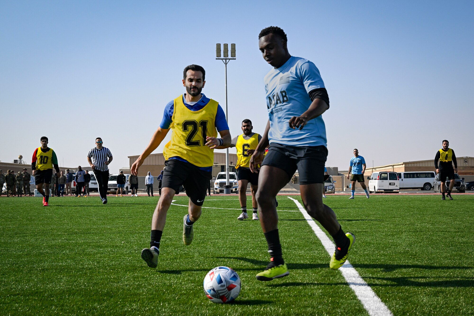 Two men play soccer.