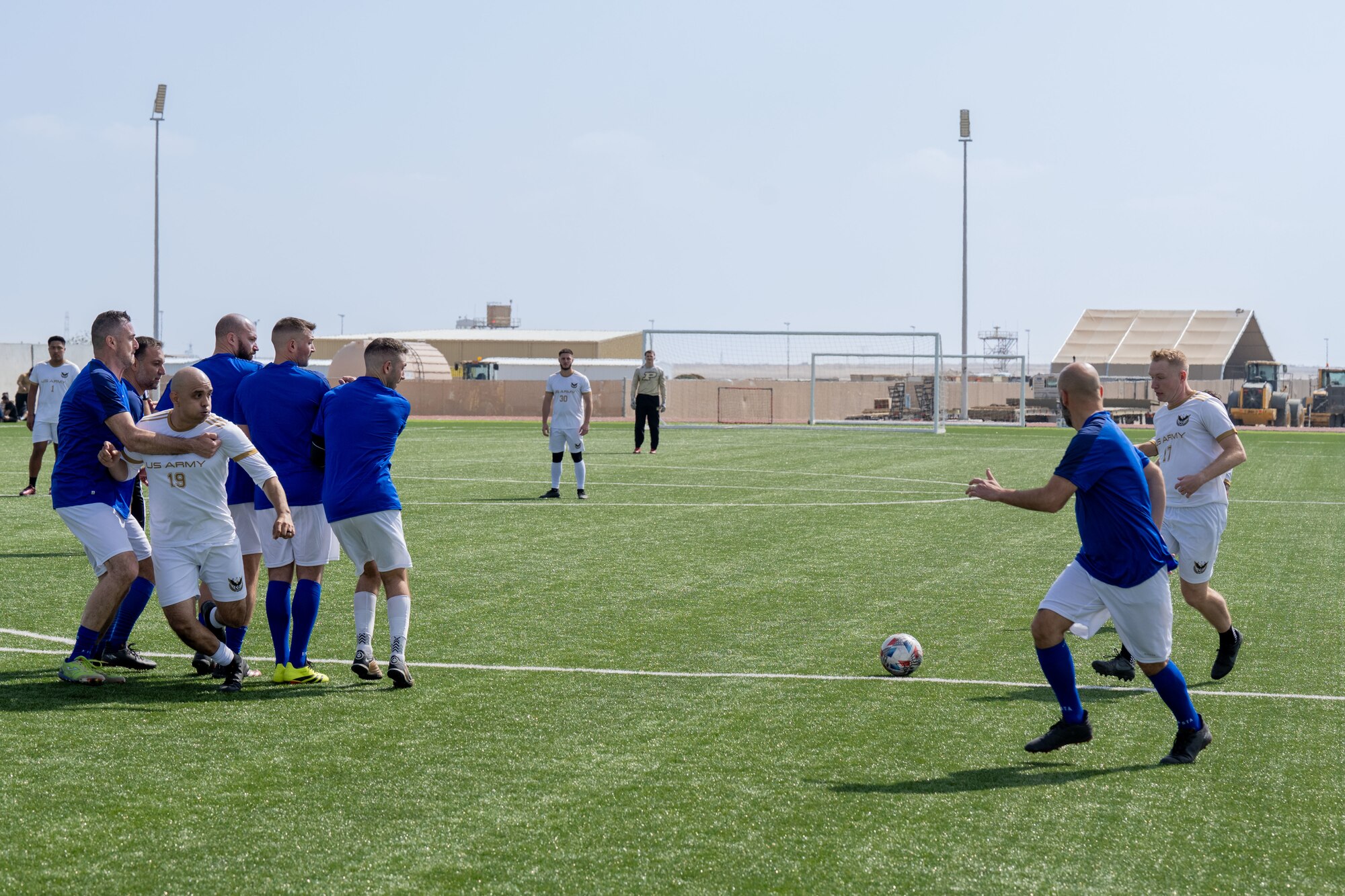 Men play soccer.
