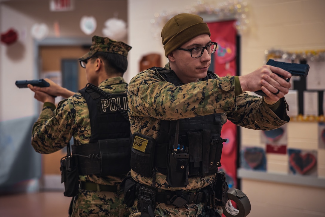 U.S. Marine Corps Cpl. Wyatt Frank, a military police officer with Security Battalion, right, responds during an active shooter drill on Marine Corps Base Quantico, Virginia, Feb. 14, 2025. These drills are conducted to educate and train the Marines with the Provost Marshall Office and employees of the Child Development Centers on the proper actions to take in the event of an active shooter. (US Marine Corps photo by Lance Cpl. Joaquin Dela Torre)