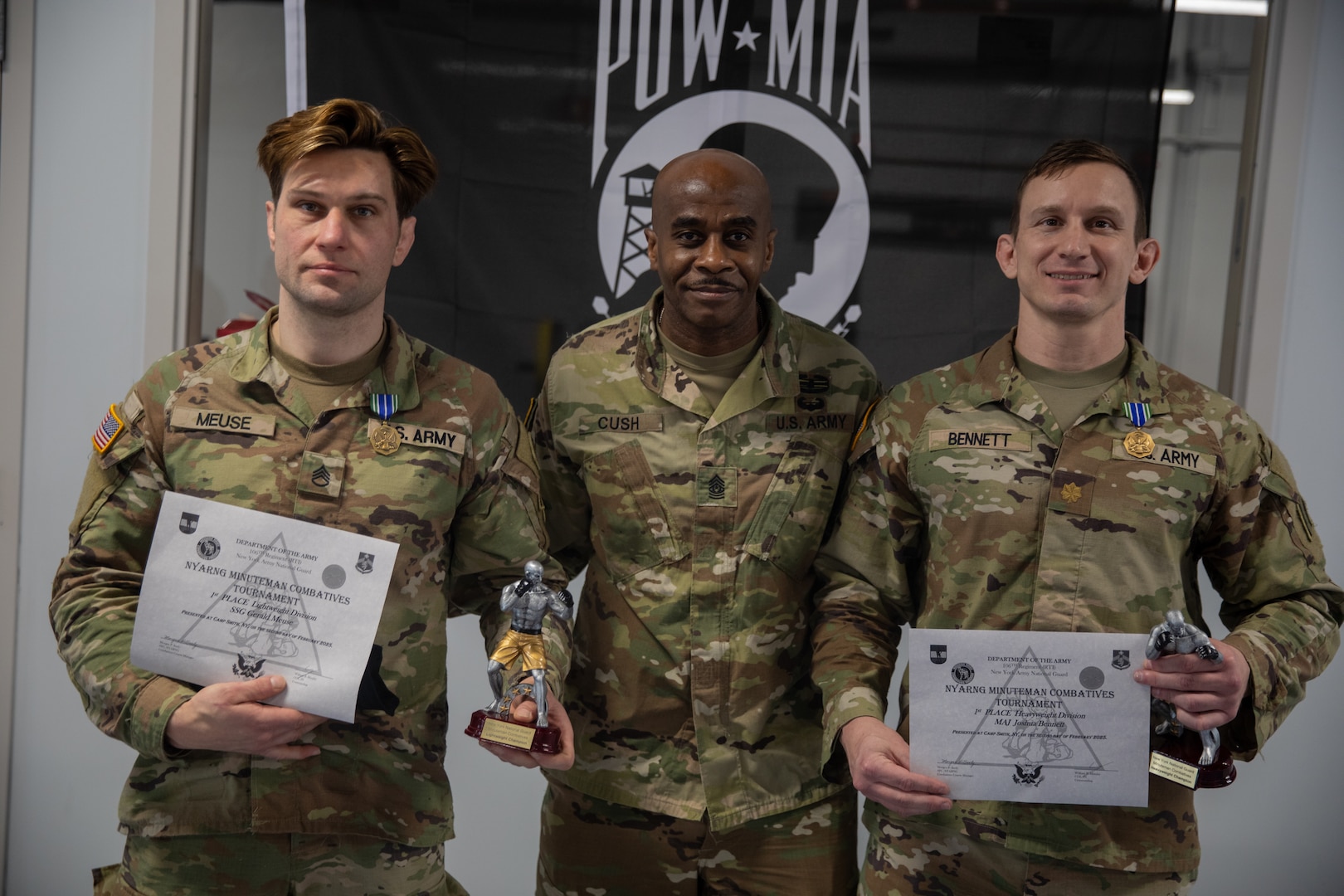 Massachusetts Army National Guard Staff Sgt. Gerald Meuse, assigned to 1st Battalion, 182nd Infantry Regiment, and New York National Guard Maj. Joshua Bennet, assigned to the 42nd Infantry Higher Headquarters Battalion, are awarded lightweight and heavyweight awards in the Minutemen competition at Camp Smith Training Site, N.Y., Feb.2, 2025. The two-day event tested military members' combat training in martial arts disciplines.