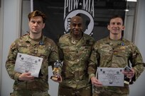Massachusetts Army National Guard Staff Sgt. Gerald Meuse, assigned to 1st Battalion, 182nd Infantry Regiment, and New York National Guard Maj. Joshua Bennet, assigned to the 42nd Infantry Higher Headquarters Battalion, are awarded lightweight and heavyweight awards in the Minutemen competition at Camp Smith Training Site, N.Y., Feb.2, 2025. The two-day event tested military members' combat training in martial arts disciplines.