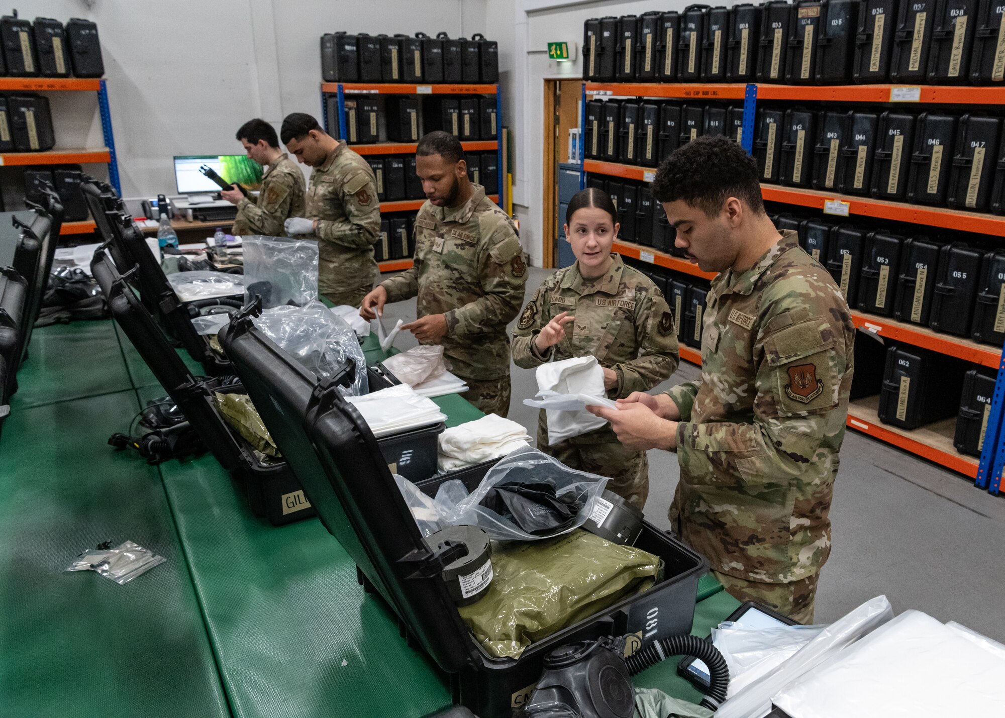 U.S. Airmen assigned to the 100th Operations Support Squadron examine decontamination bags at RAF Mildenhall, England, Feb. 6, 2025.