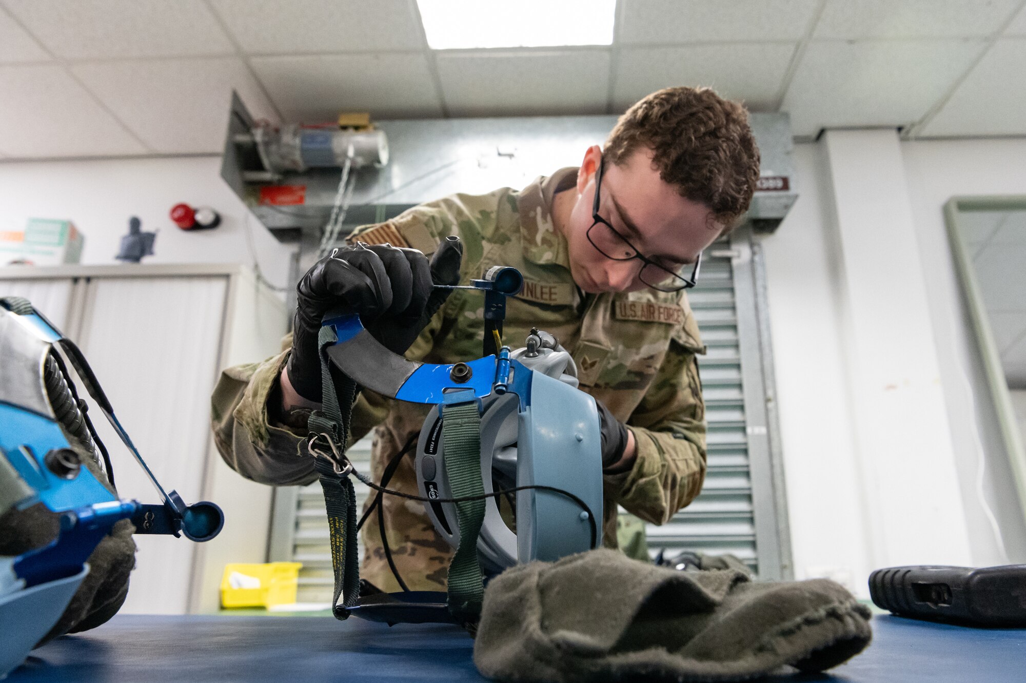 U.S. Air Force Senior Airman Jonathan Brownlee, 100th Operations Support Squadron aircrew flight equipment technician, inspects an oxygen mask at RAF Mildenhall, England, Feb. 6, 2025.