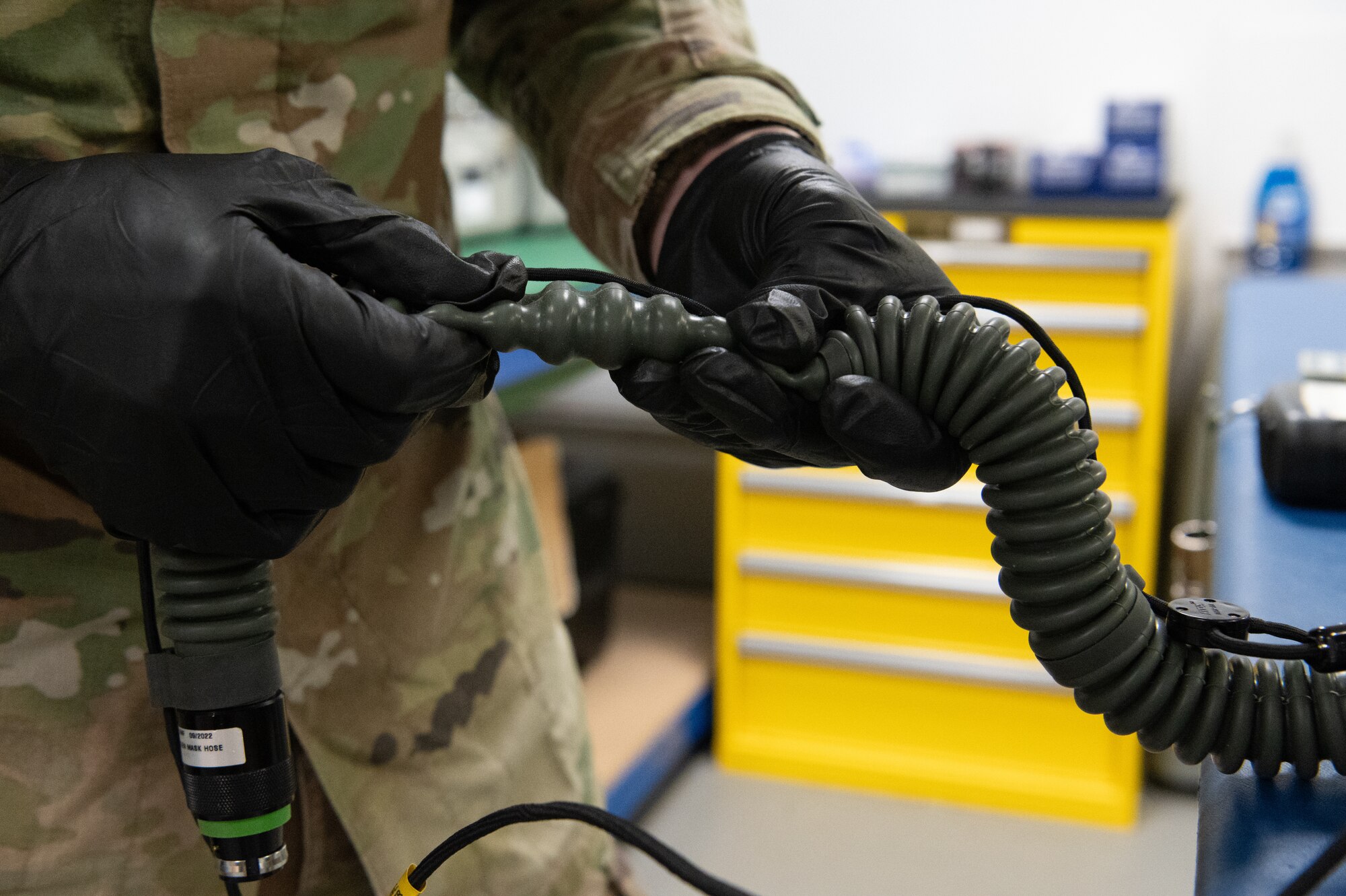 U.S. Air Force Senior Airman Jonathan Brownlee, 100th Operations Support Squadron aircrew flight equipment technician, inspects the hose on an oxygen mask at RAF Mildenhall, England, Feb. 6, 2025.