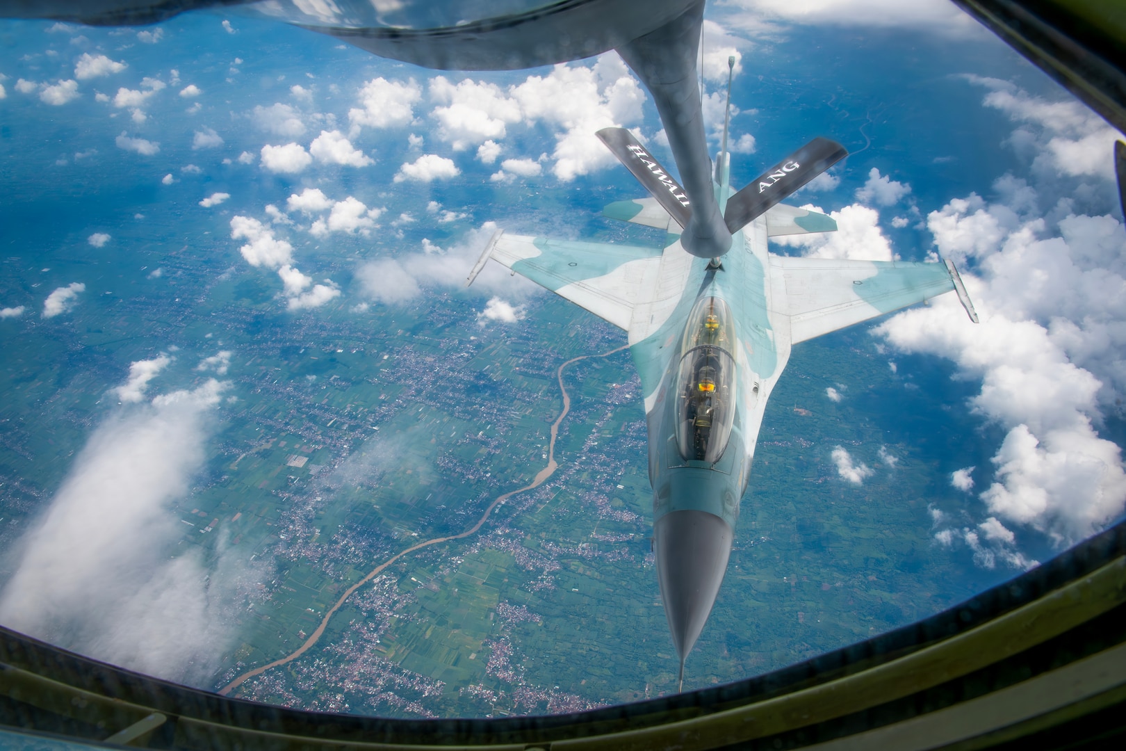 An Indonesian Air Force F-16 Fighting Falcon flies alongside a Hawaii Air National Guard KC-135 Stratotanker assigned to the 203rd Air Refueling Squadron during an air-to-air refueling training mission over Indonesia Feb. 19, 2025. The Hawaii National Guard and Indonesia are State Partnership Program partners.