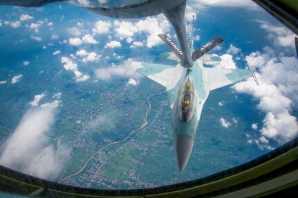 An Indonesian Air Force F-16 Fighting Falcon flies alongside a Hawaii Air National Guard KC-135 Stratotanker assigned to the 203rd Air Refueling Squadron during an air-to-air refueling training mission over Indonesia Feb. 19, 2025. The Hawaii National Guard and Indonesia are State Partnership Program partners.