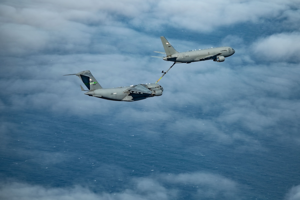 A KC-46 Pegasus aircraft makes contact with a C-17 Globemaster III aircraft  to conduct a low-altitude aerial refueling mission over the Pacific Ocean during Exercise Bamboo Eagle 25-1.