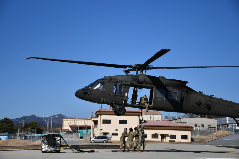 Soldiers at the U.S. Army Medical Materiel Center-Korea take part in joint sling load training Feb. 13 with the 2nd Combat Aviation Brigade at Camp Carroll, Republic of Korea. The Army Sling Load Program provides the skills to rig and securely attach various loads to a helicopter, ensuring rapid transport of supplies, equipment and vehicles.