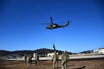 Soldiers at the U.S. Army Medical Materiel Center-Korea take part in joint sling load training Feb. 13 with the 2nd Combat Aviation Brigade at Camp Carroll, Republic of Korea. The Army Sling Load Program provides the skills to rig and securely attach various loads to a helicopter, ensuring rapid transport of supplies, equipment and vehicles.