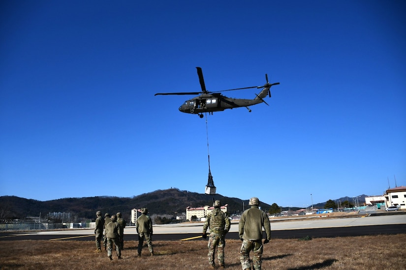 Soldiers at the U.S. Army Medical Materiel Center-Korea take part in joint sling load training Feb. 13 with the 2nd Combat Aviation Brigade at Camp Carroll, Republic of Korea. The Army Sling Load Program provides the skills to rig and securely attach various loads to a helicopter, ensuring rapid transport of supplies, equipment and vehicles.