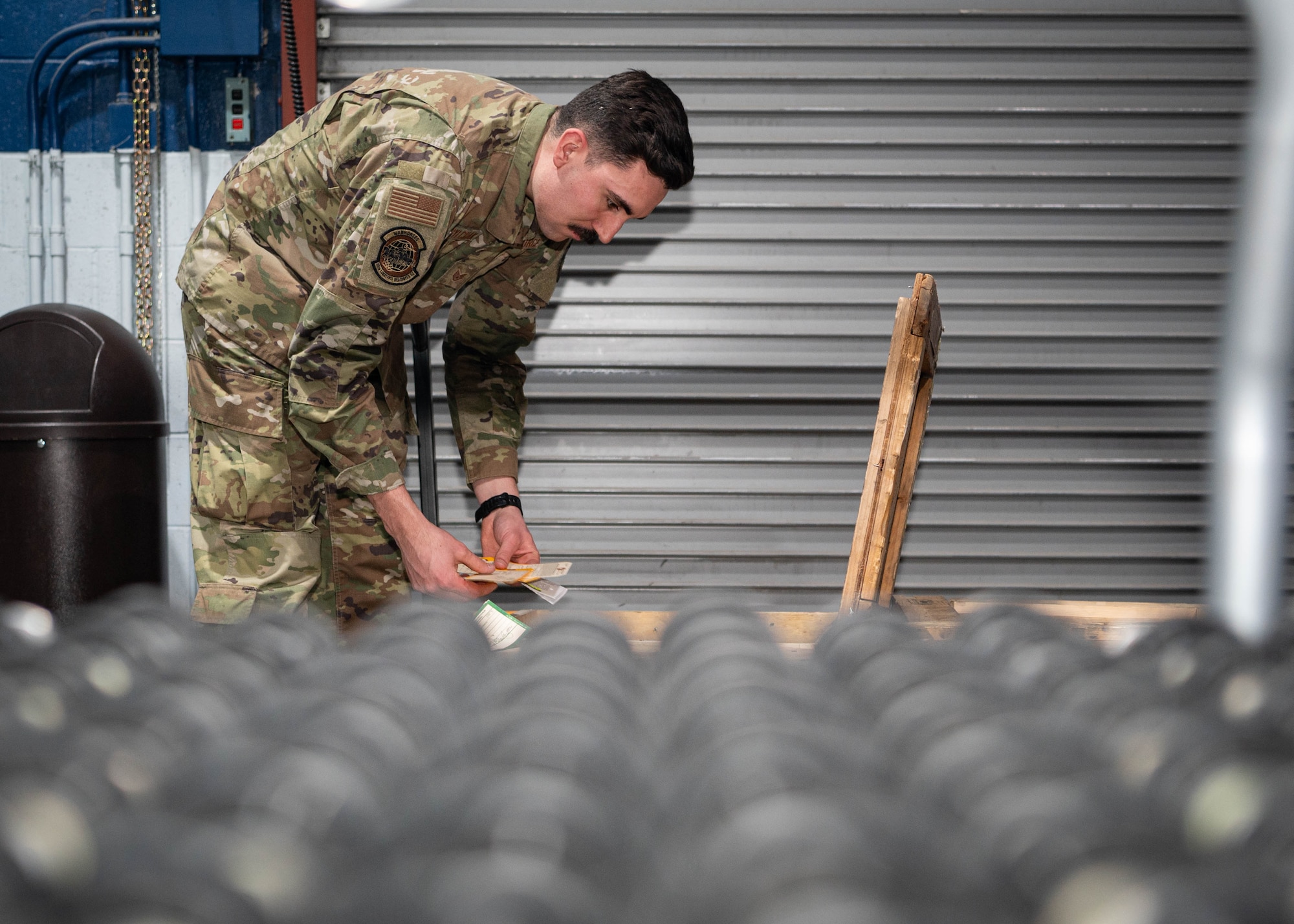 Staff Sgt. Rick Wasylchak, 55th Logistics Readiness Squadron NCO-in-charge of the maintenance support flight service center, looks over serial numbers from a crate of aircraft parts at the Bennie Davis facility Feb. 20, 2025.