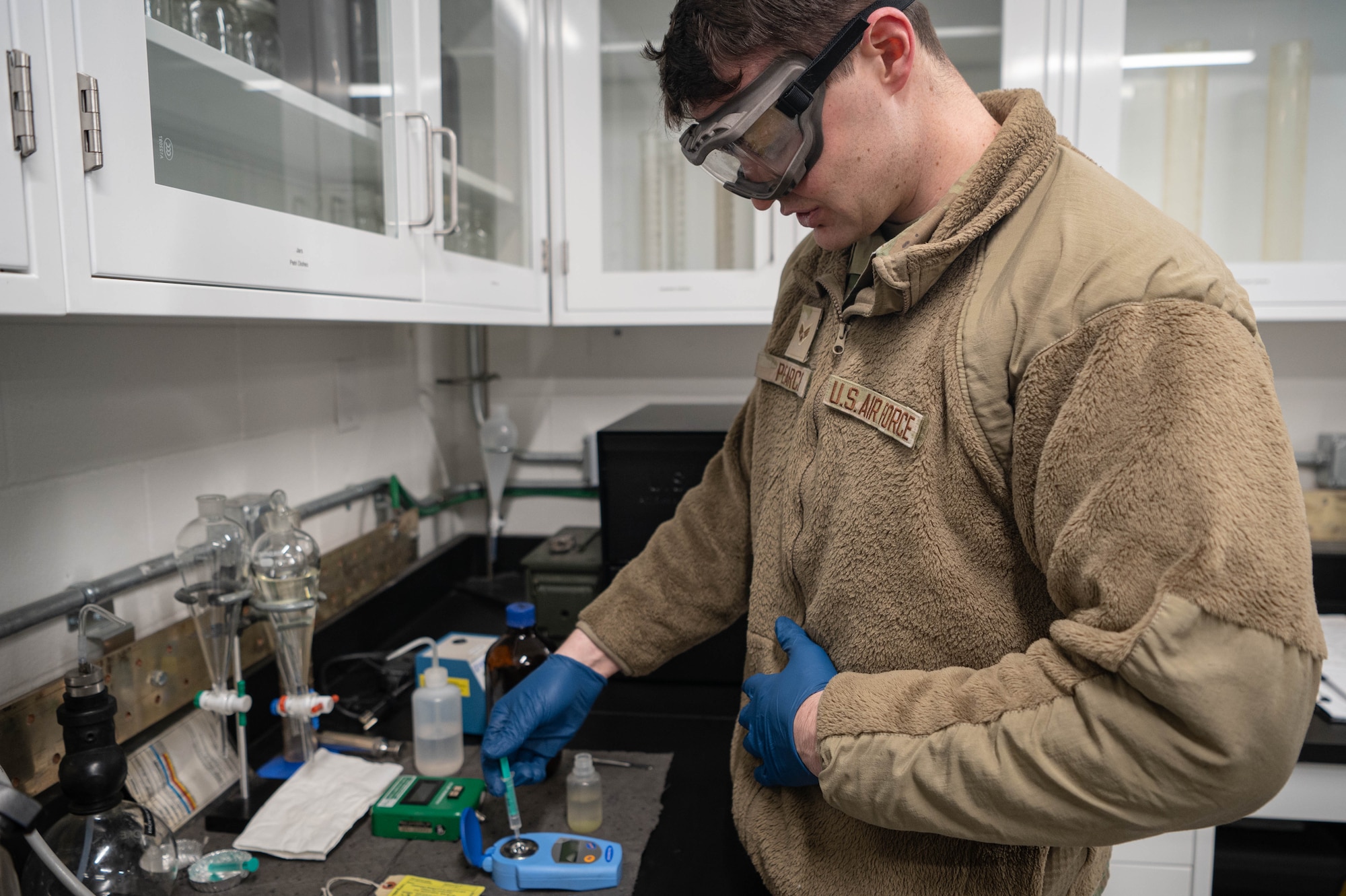 Senior Airman Devon Pearce, 55th Logistics Readiness Squadron fuel laboratory technician, prepares a jet fuel sample for testing Feb. 21, 2025. Testing is done to ensure there are no impurities or contaminants that may affect performance.