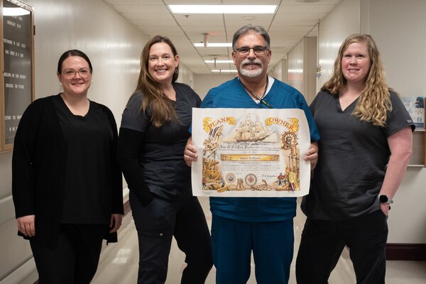 Mr. Edward Sorzano, center right with certificate, stands with the Naval Health Clinic Cherry Point Radiology Team on Wednesday, February 19, 2025.  Sorzano is a “Plank Owner” of the organization, having served at the clinic during its first year of operation in 2007.  He retired from the clinic in late February after more than two decades of service as a General Schedule Civilian.



During his time there, he helped train more than 100 Radiology students from Carteret Community College while increasing the department’s radiology capabilities to include Magnetic Resonance Imaging and Computed Tomography.