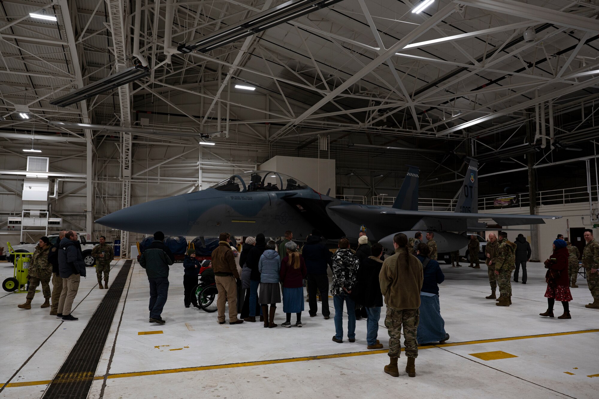 Airmen and civilians gather around an F-15 EX Eagle II assigned to Eglin Air Force Base, Fla., during a tour commemorating Project Streak Eagle and world record setting airframes at Grand Forks AFB, N.D., Feb. 20, 2025.