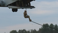2nd Lt. Kyle Funk, military police officer, 323rd Military Police Company, conducts fast rope insertion and extraction system training out of a CH-53K King Stallion helicopter during Exercise Northern Strike at Alpena Combat Readiness Training Center, Alpena, Mich., Aug. 5, 2024. Fast-roping is a technique for descending a thick rope, allowing troops to deploy from a helicopter in places where the aircraft cannot touch down.
