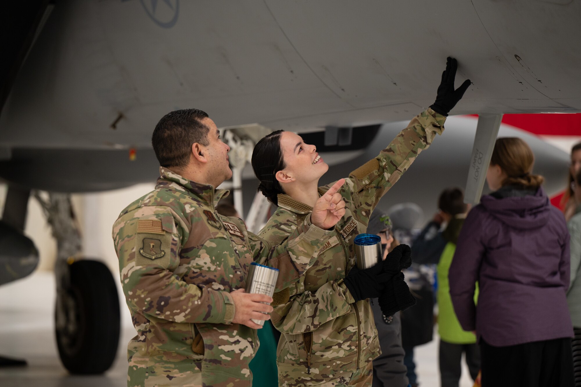 Capt. Fernando Monsalve, 319th Reconnaissance Wing chaplain, and Staff Sgt. Lillian Stidham, 319th RW religious affairs airman, tour an F-15 EX Eagle II assigned to the 53rd Wing at Eglin Air Force Base, Fla., at Grand Forks Air Force Base, N.D., Feb. 20, 2025.