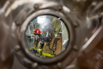 Sailors conduct damage control training aboard USS Ralph Johnson (DDG 114) in Sagami Bay.