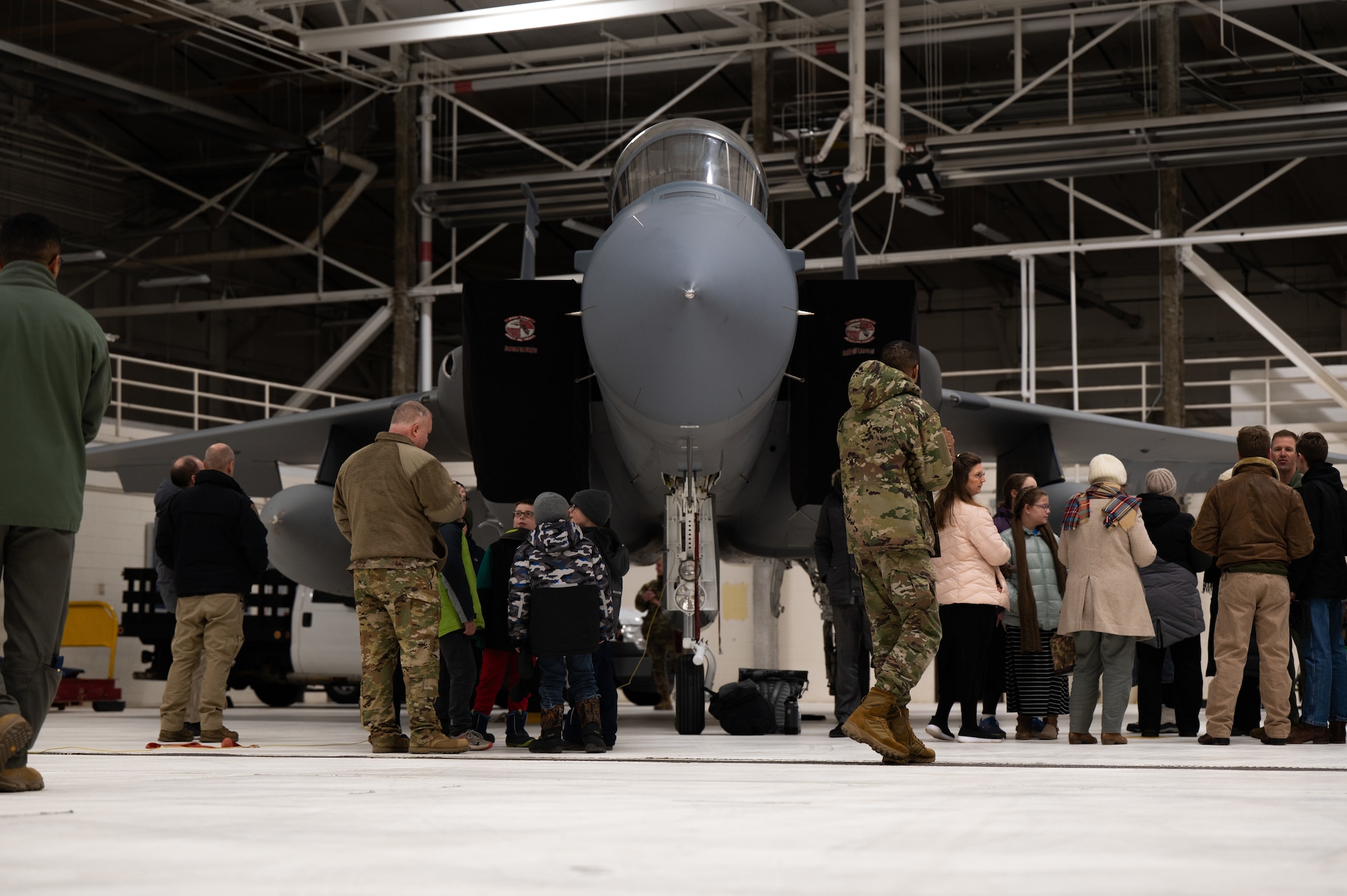 Airmen assigned to the 319th Reconnaissance Wing and local civilian guests observe an F-15 EX Eagle II from the 53rd Wing at Eglin Air Force Base, Fla., at Grand Forks Air Force Base, N.D., Feb. 20, 2025.