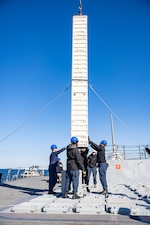 Sailors load a standard missile (SM) 2 into the vertical launching system aboard USS Ralph Johnson (DDG 114) in Sagami Bay.