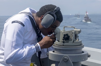 Quartermaster 3rd Class Edward Wheeling stands watch on the bridge-wing aboard USS Dewey (DDG 105) during Multinational Exercise Komodo (MNEK) 2025, in the Bali Sea.