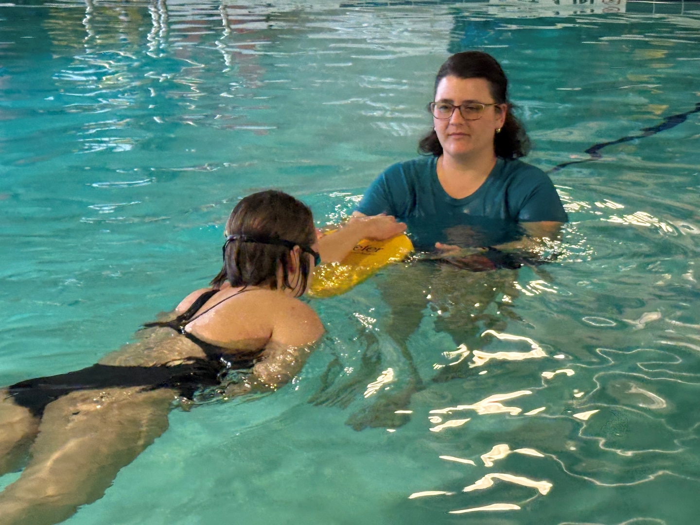 Cara Navarro, a recreational therapist in the Department of Rehabilitation at Walter Reed, works with a patient in the therapeutic pool at Walter Reed on Feb. 18, 2025. “Having the opportunity to serve our military and their families is what I find most rewarding about working at Walter Reed,” said Navarro.