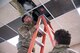 Senior Airman Kyle Corcoran, a heating, ventilation, air conditioning and refrigeration specialist assigned to the 5th Civil Engineer Squadron, inspects an infrared heater at the Combat Arms Training and Maintenance building on Minot Air Force Base, North Dakota, Feb. 18, 2025. Functional airflow is important in the CATM range because downrange airflow prevents firearm debris from blowing back toward Airmen. (U.S. Air Force photo by Senior Airman Kendra A. Ransum)