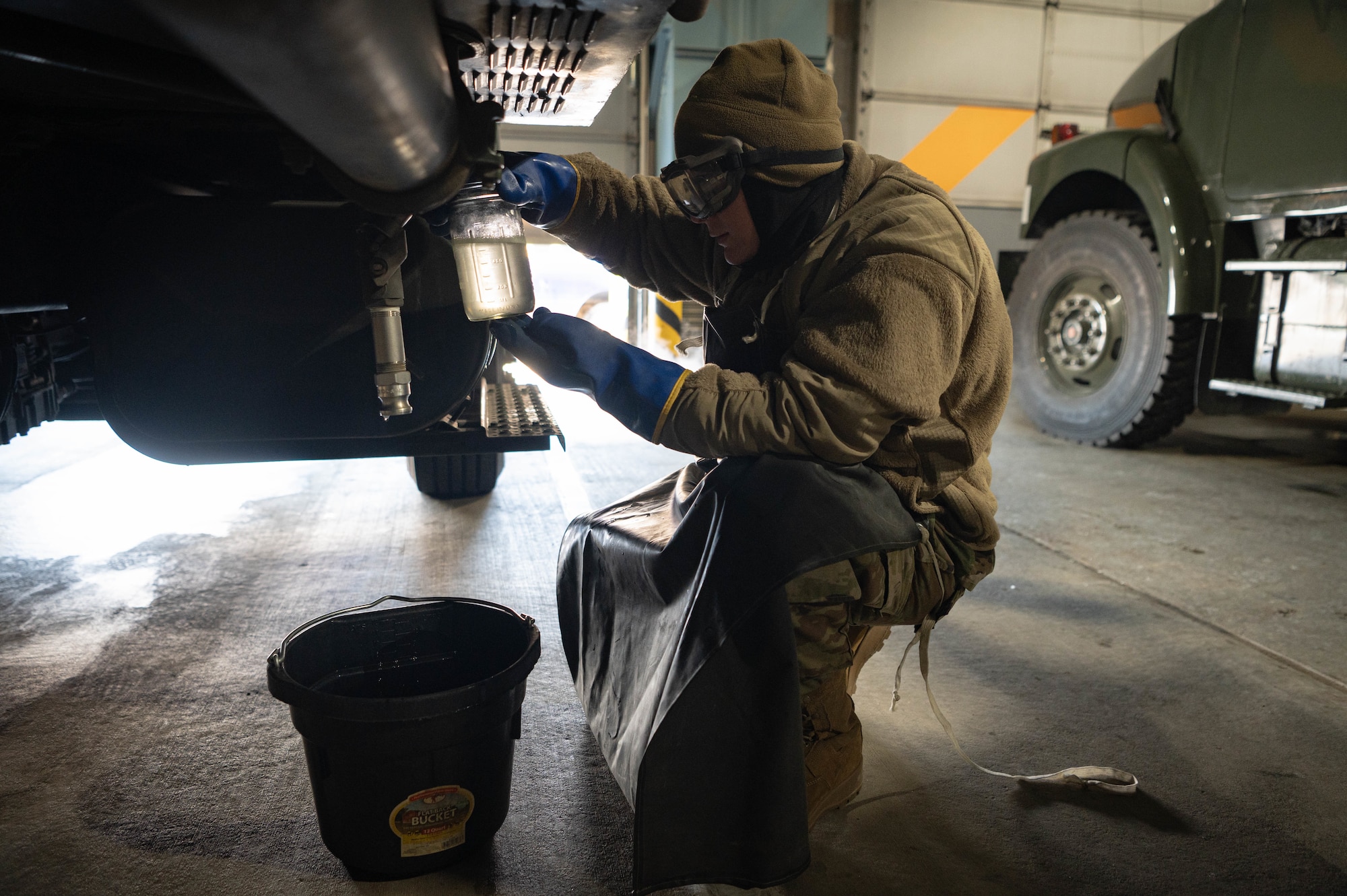 Airman 1st Class Cameron McGurk, 55th Logistics Readiness Squadron fuels distribution operator, looks over a jet fuel sample he collected for testing Feb. 21, 2025. Testing is done to ensure there are no impurities or contaminants that may affect performance.
