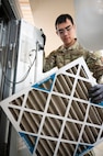 Airman 1st Class Jose Verduzco, a 5th Civil Engineer Squadron heating, ventilation, air conditioning and refrigeration specialist, removes an old filter from an air handling unit at the Child Development Center on Minot Air Force Base, North Dakota, Feb. 19, 2025. These specialists are responsible for the installation, maintenance and operation of HVAC/R systems and equipment necessary for Airmen to complete operations in a variety of climates all over the world. (U.S. Air Force photo by Senior Airman Kendra A. Ransum)