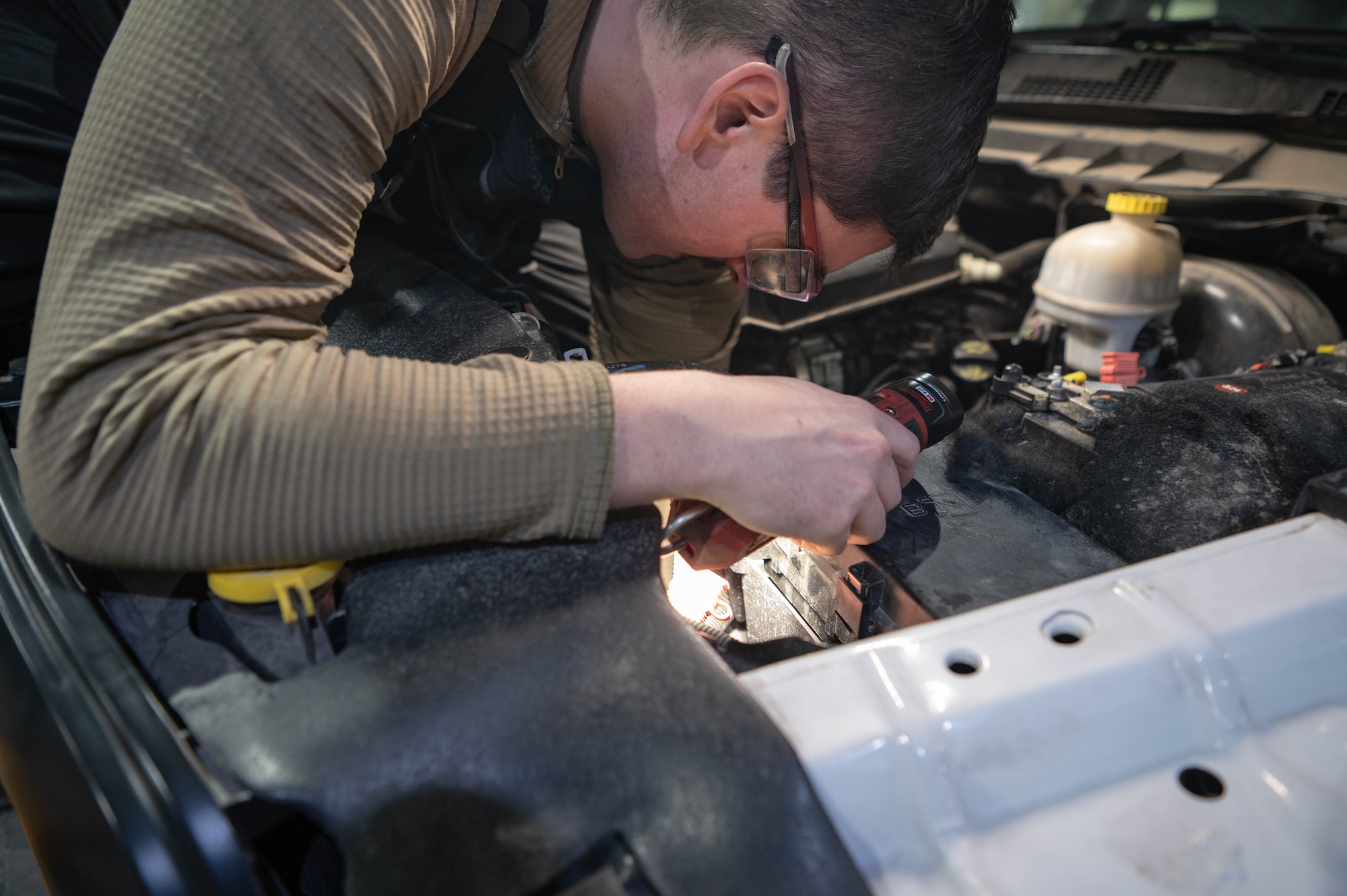 Senior Airman Sean Bacon, 55th Logistics Readiness Squadron vehicle maintenance supervisor, loosens a bolt to an engine part while performing maintenance on a vehicle in Building D Feb. 21, 2025.