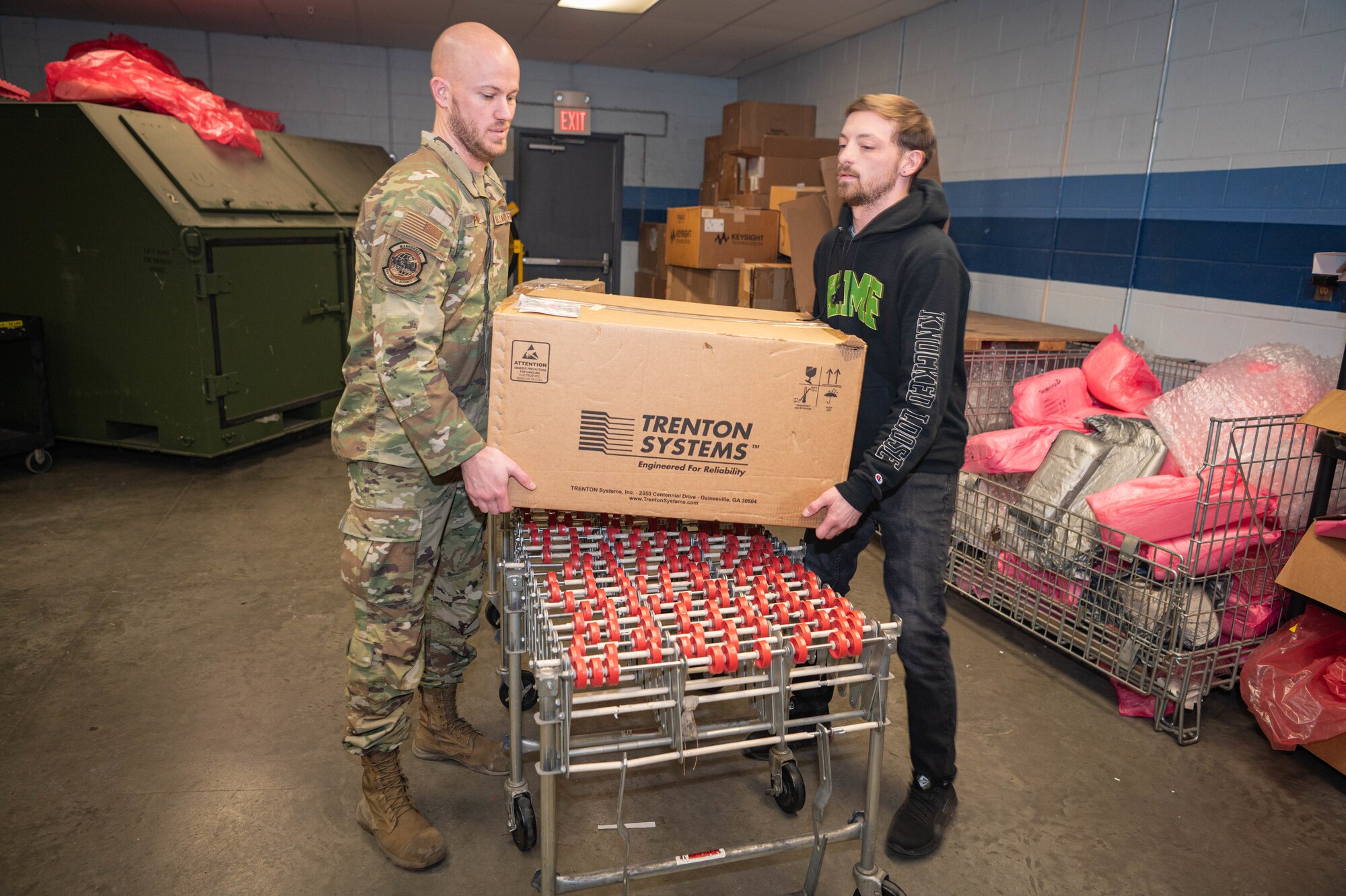 Tech. Sgt. Tyler Powers, 55th Logistics Readiness Squadron NCO-in-charge of special depot support, and Daniel Kopcik, 55th LRS supply technician, move a box for palletizing as part of an air cargo shipment at the Bennie Davis facility Feb. 20, 2025.