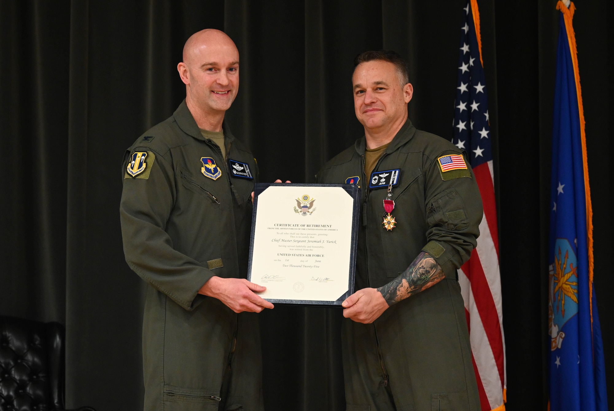 Two men pose with an award.