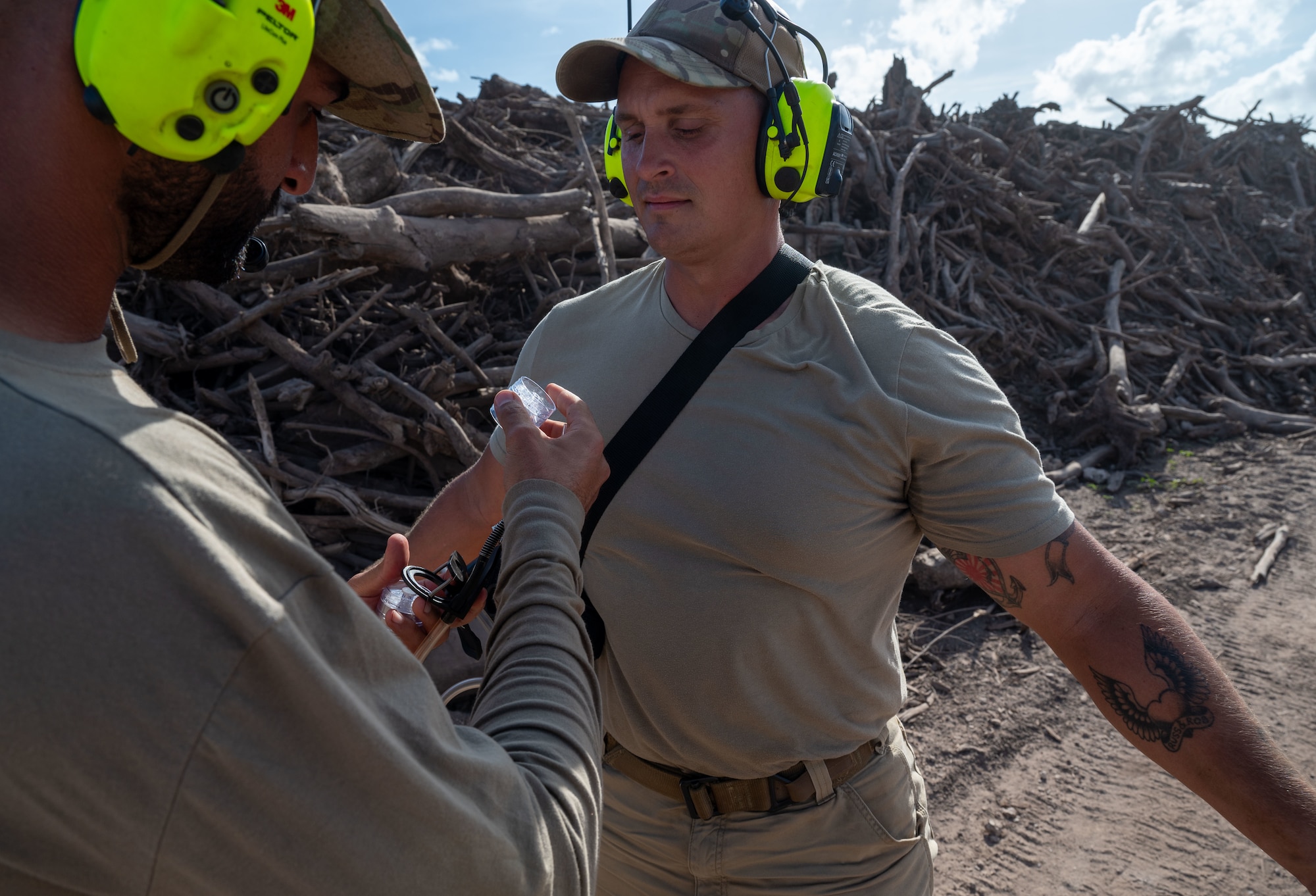 U.S. Air Force Master Sgt. Omar Salih, 356th Expeditionary Civil Engineer Group safety superintendent, draws air samples from Tech. Sgt. Cody Rohrs, 513th Expeditionary Rapid Engineer Deployable Heavy Operations Repair Squadron Engineers Squadron pavement and construction equipment craftsman, for nuisance particles at Tinian’s North Field, Tinian, Feb. 03, 2025. Sailh was trained by bioenvironmental engineers to survey ECEG Airmen on Tinian since there is no installation bioenvironmental engineering unit on the island. (U.S. Air Force photo by Airman 1st Class Manasseh Demissie)